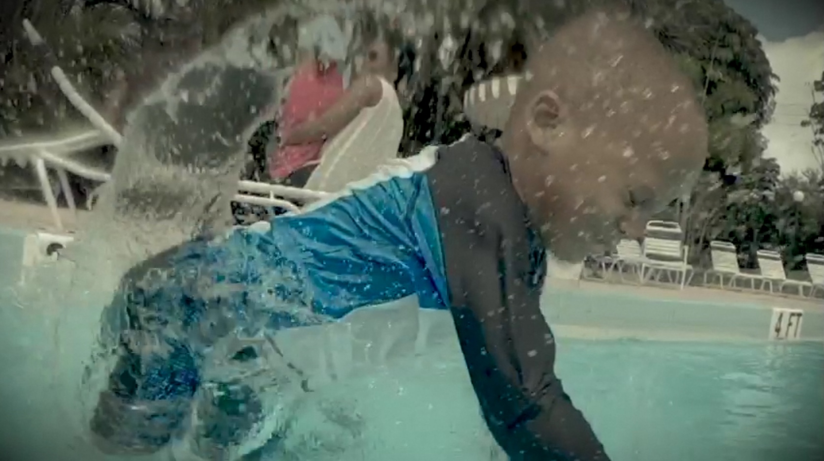 Child jumping into pool