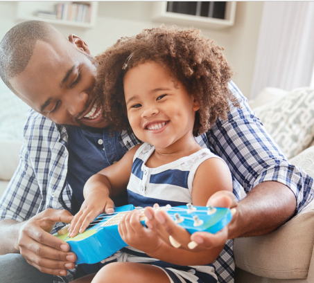 PARENTING: Teaching to See Things Differently - Dad and child playing with toy guitar