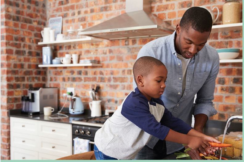 father and Son washing Vegetables