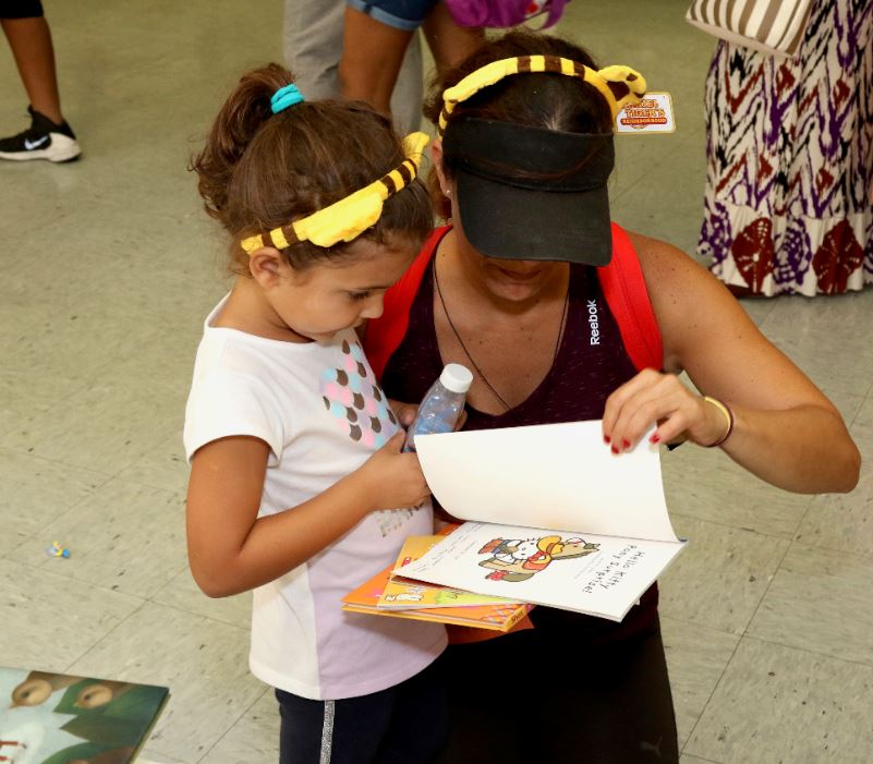 child and mother reading a book