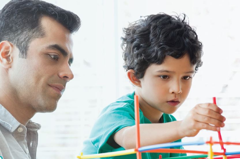 A Father and a child building with bricks 