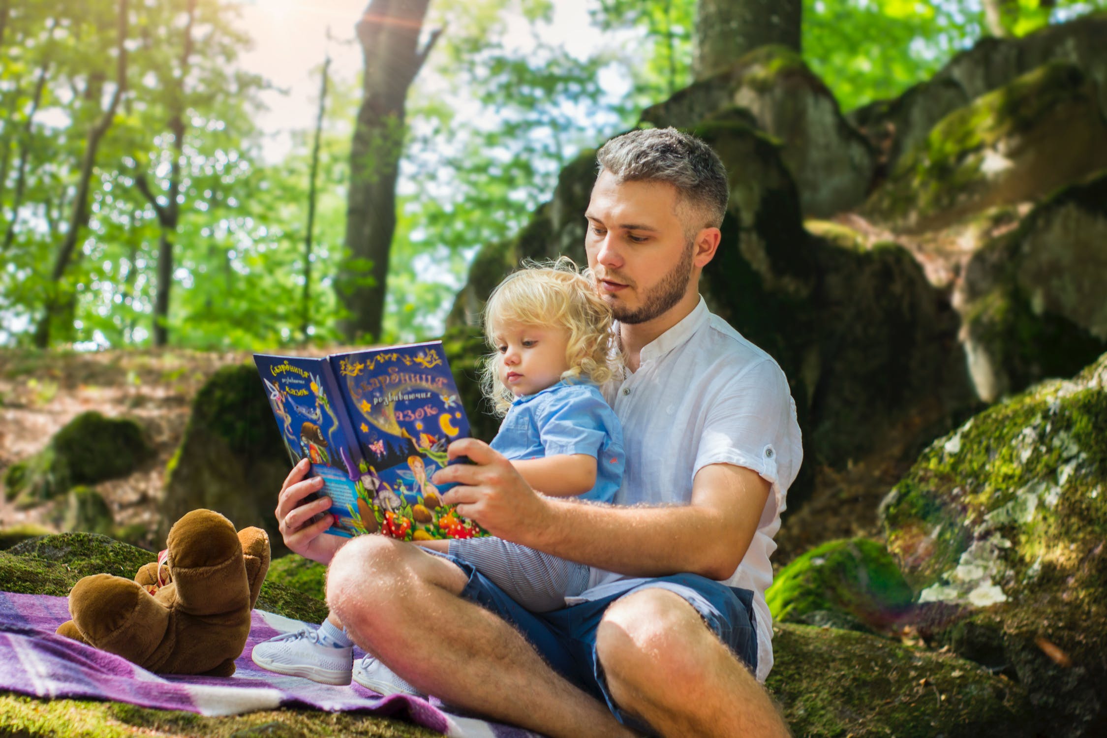 Father reading book to daughter.