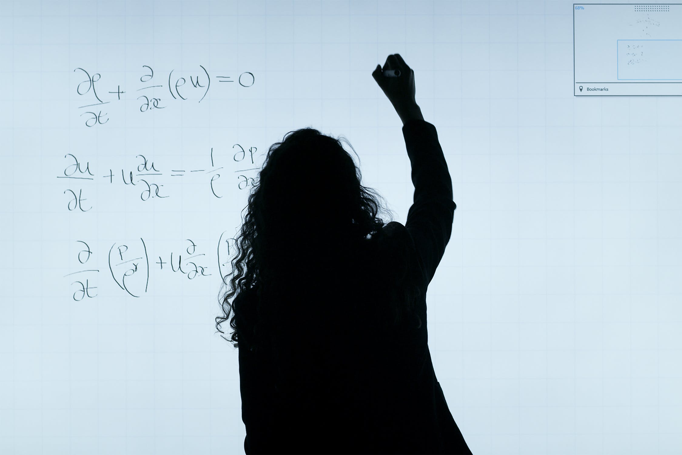 Woman writing equation.