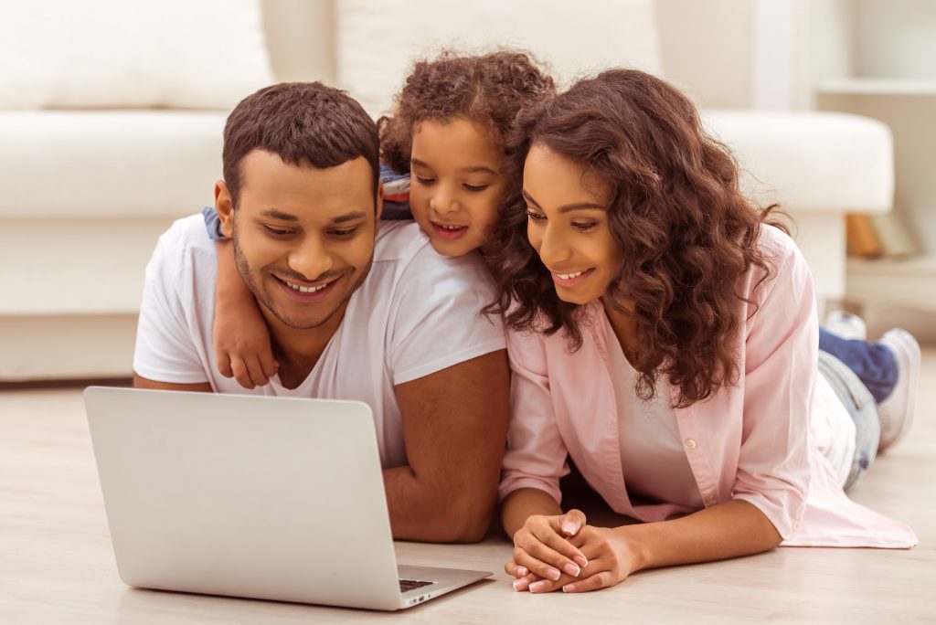 Family working on laptop computer.