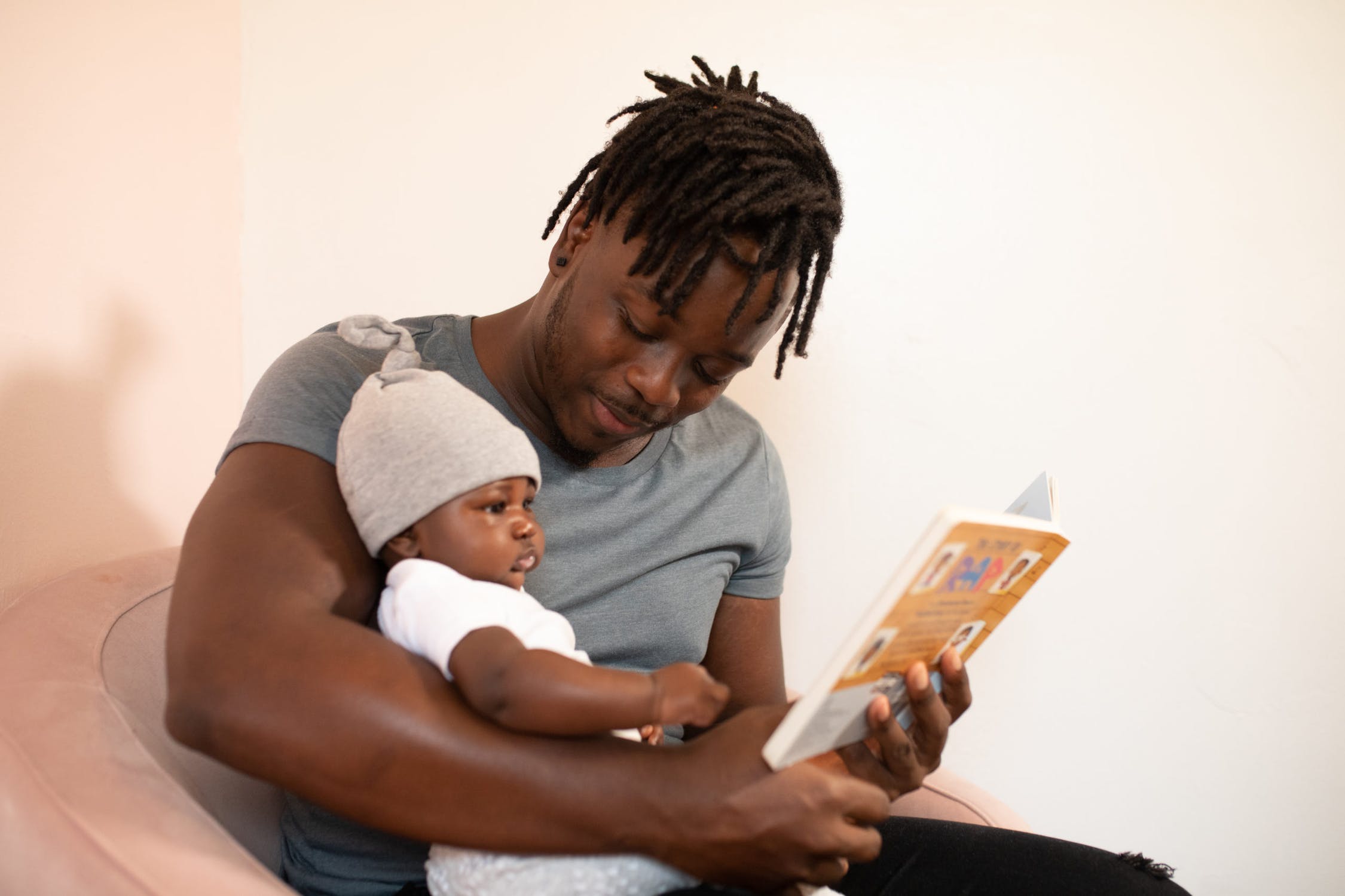 Father reading to the baby. 