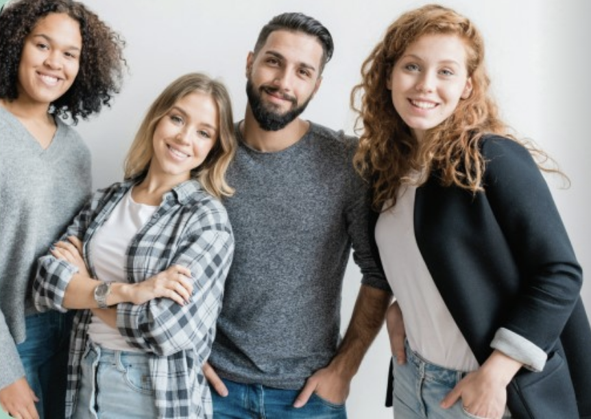 one male and three female smiling together