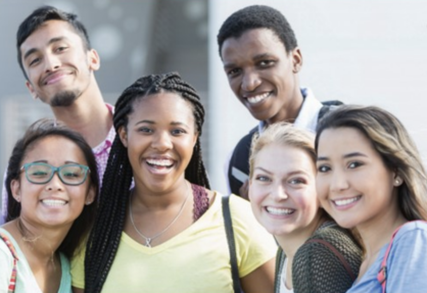 Two males and four females are smiling together