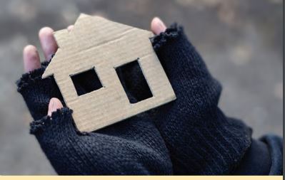 Hands holding a cardboard house shape