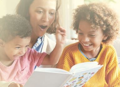 A Mother with two children enjoying a book