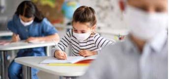 Girl writing in a notebook in the classroom