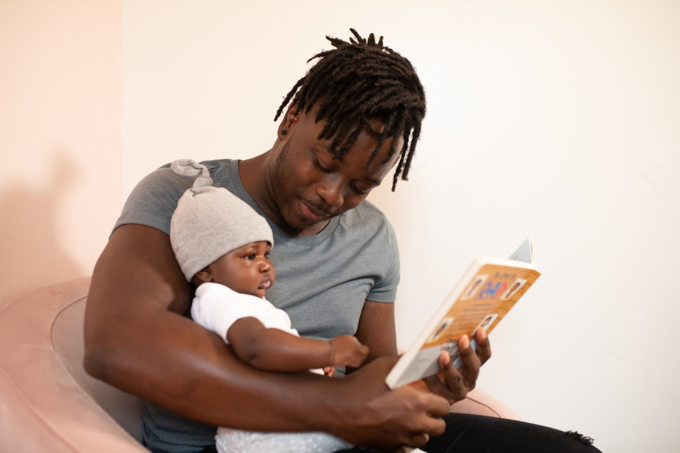 Father reading to baby.